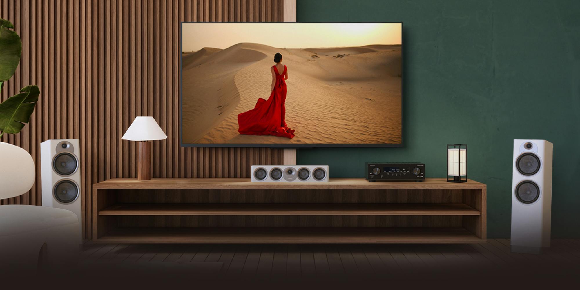 Pioneer VSX 835 powering home Jamo system with red dress woman on tv 2000x1000